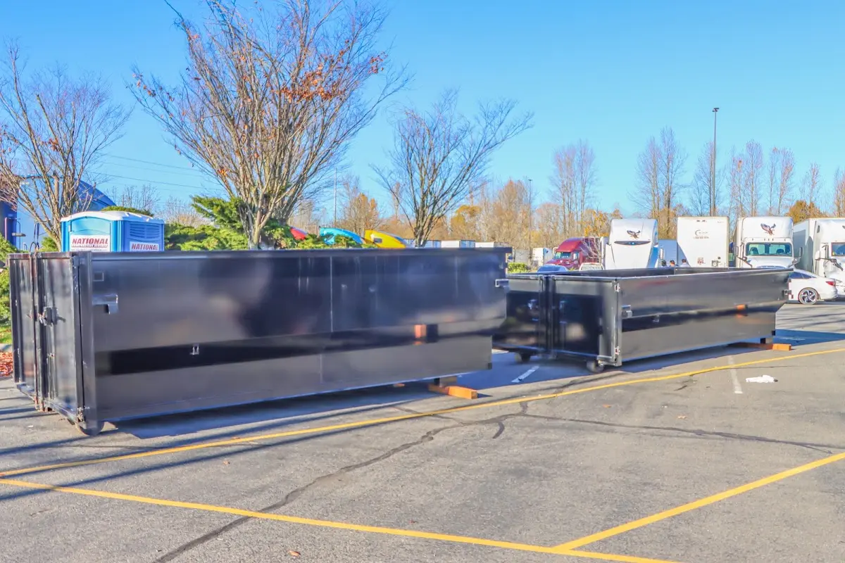 Professional dumpster rental service with roll-off container on residential driveway in North Ridgeville